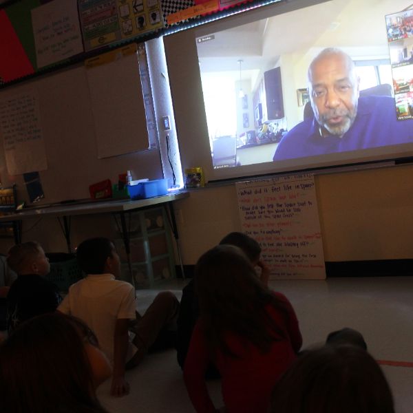  Man on screen in Zoom call with students