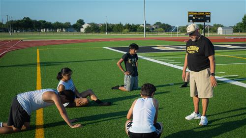 Chavez working with students following a workout.