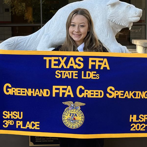  Student holding FFA award banner