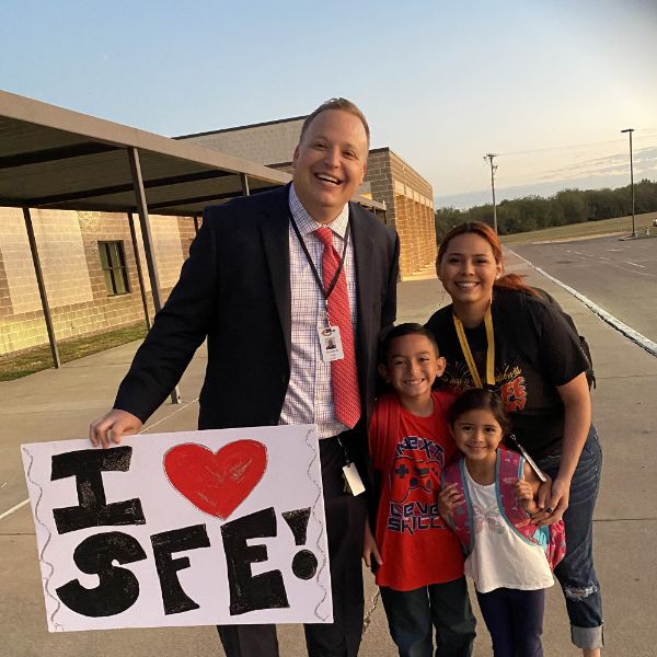  Man with a sign, with a woman and two children also pictured